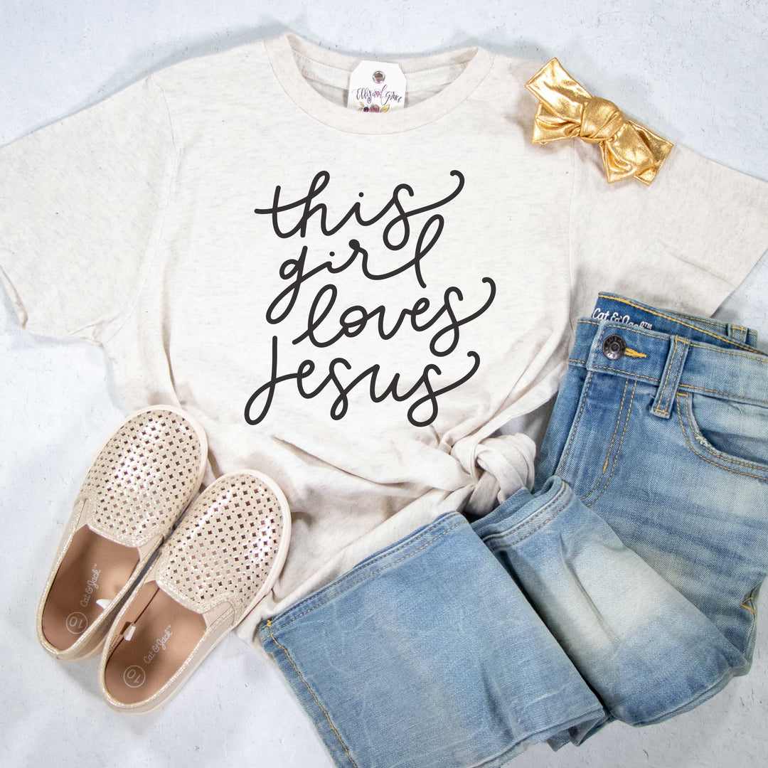 ellyandgrace 6101 Unisex Youth Large / Heather Natural This Girl Loves Jesus Unisex Youth Shirt