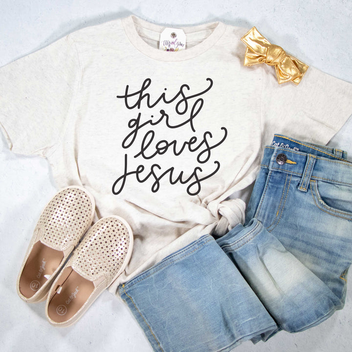 ellyandgrace 6101 Unisex Youth Large / Heather Natural This Girl Loves Jesus Unisex Youth Shirt