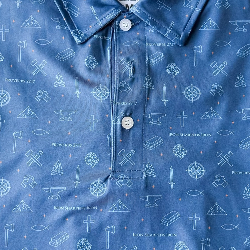 Close-up of the Iron Sharpens Iron polo fabric showing Proverbs 27:17 woven into the all-over print